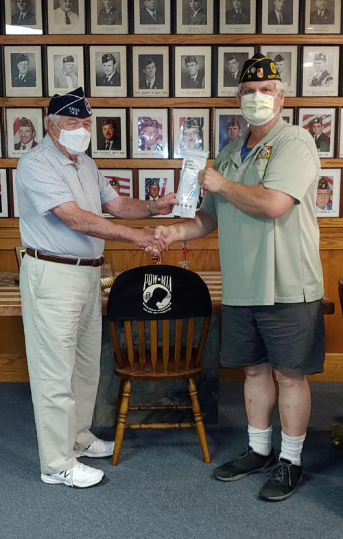 Post 11 Commander David Swiderski accepting a donation of masks by KWVA Chapter 142 Commander Frederick Becker