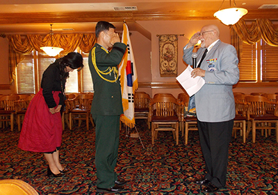 Commander Mobely salutes Major General Shin